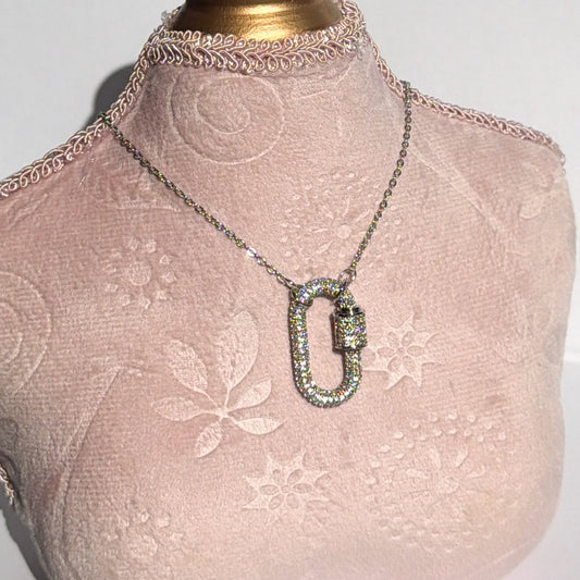 Mannequin bust with pink lace garment and necklace on a white background