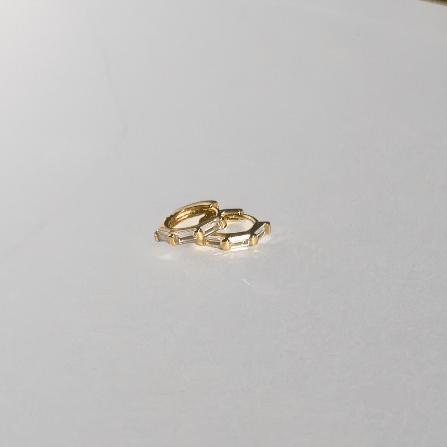 Gold ring on a light gray surface