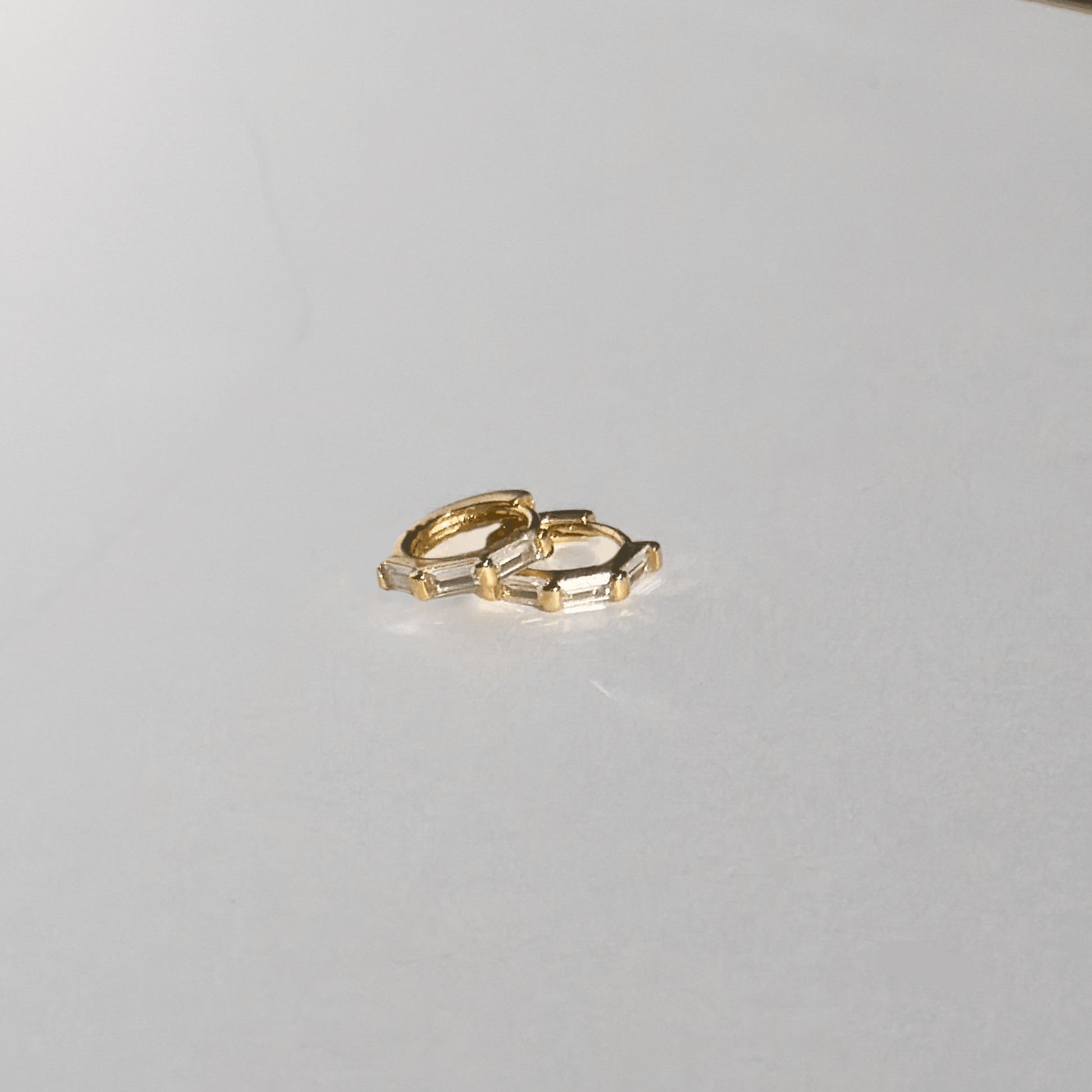 Gold ring on a light gray surface