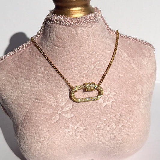 Mannequin bust with lace detail wearing a gold necklace on a white background